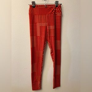 LuLaRoe One Size Leggings. Fits size 2-10. Red and white patterned.